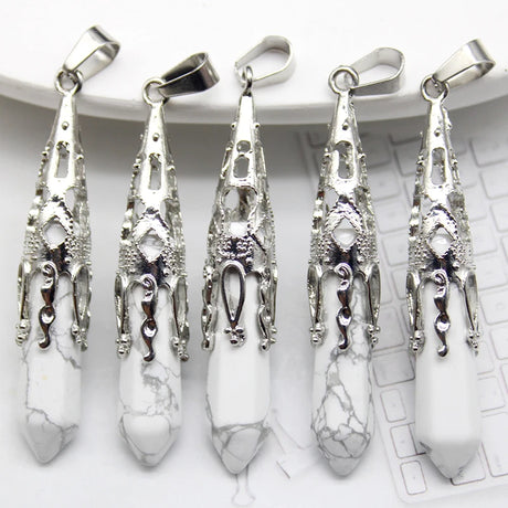Five silver pendants with white stones on a white surface
