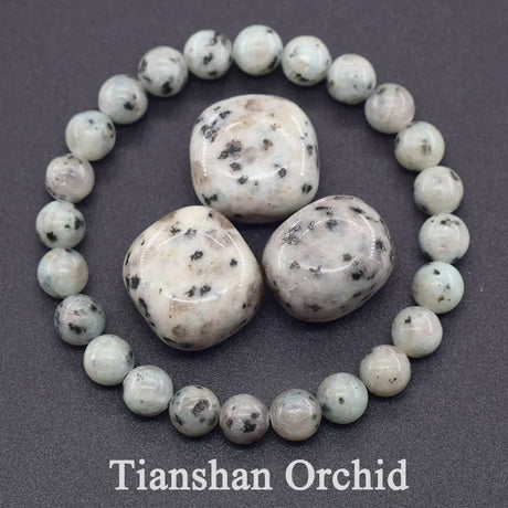 Necklace with white beads and larger stones on a gray background, featuring 'Tianshan Orchid' branding.