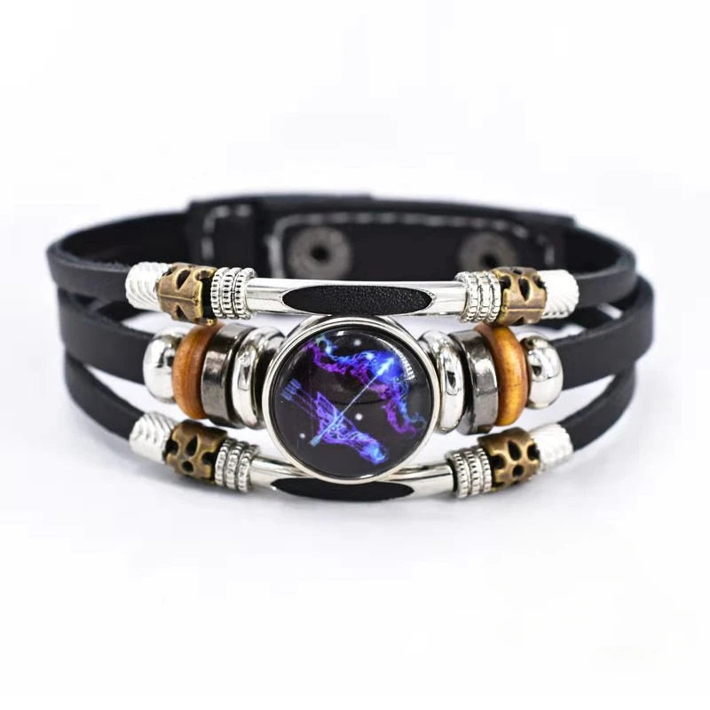 Multilayered bracelet with metallic and leather components on a white background