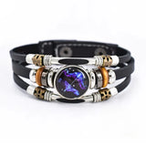 Multilayered bracelet with metallic and leather components on a white background