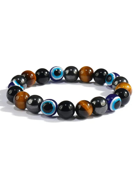 Multicolored beaded bracelet with blue evil eye beads on a white background