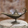 Decorative incense burner with intricate designs on a stone surface