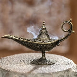 Decorative incense burner with intricate designs on a stone surface