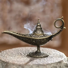 Decorative incense burner with intricate designs on a stone surface