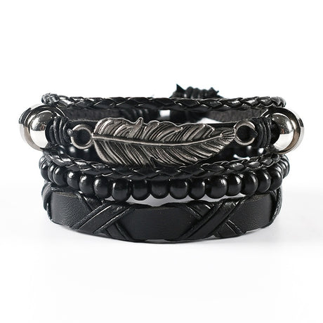 Black leather and metal bracelet with feather design on a white background