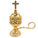 Gold incense burner with cross on top on a white background