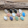 Set of colorful stone rings on a wooden surface with a natural wood background