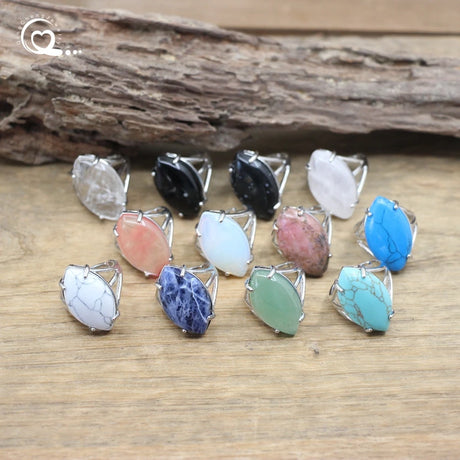 Set of colorful stone rings on a wooden surface with a natural wood background