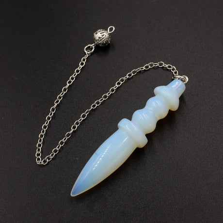 White dagger-shaped pendant on a chain against a black background