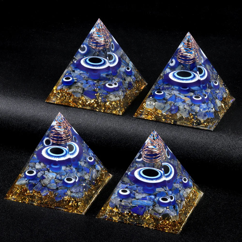 Four pyramid-shaped objects with blue and gold design on a black background