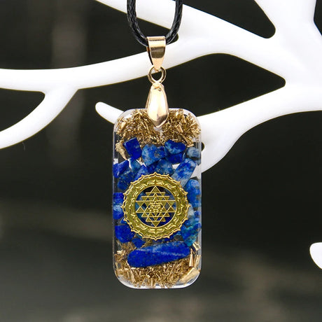 Pendant with blue and gold design on a white background