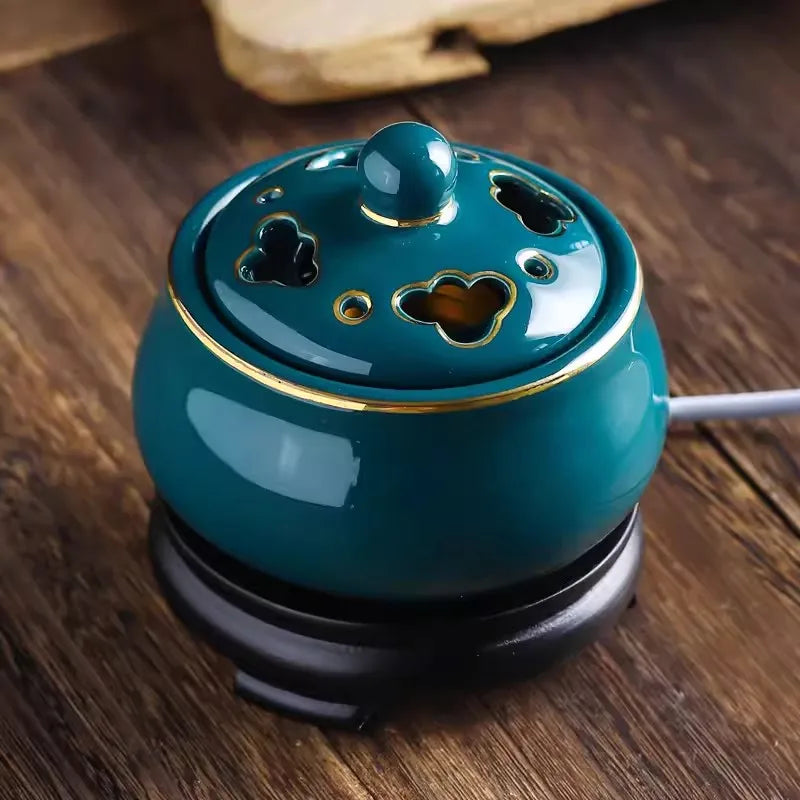 Teal ceramic diffuser on a wooden surface