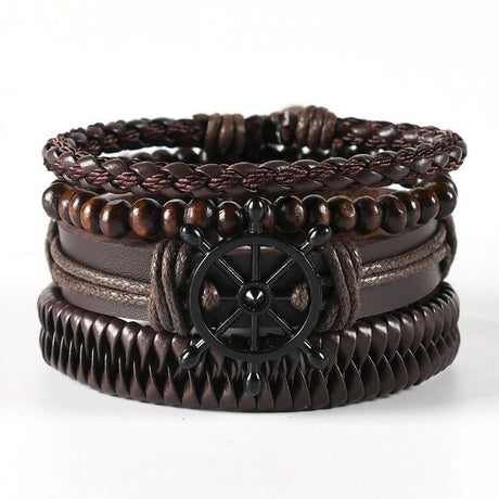 Stack of brown leather bracelets with a ship's wheel charm on a white background