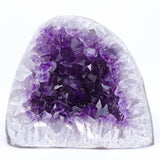 Amethyst crystal cluster on a white background
