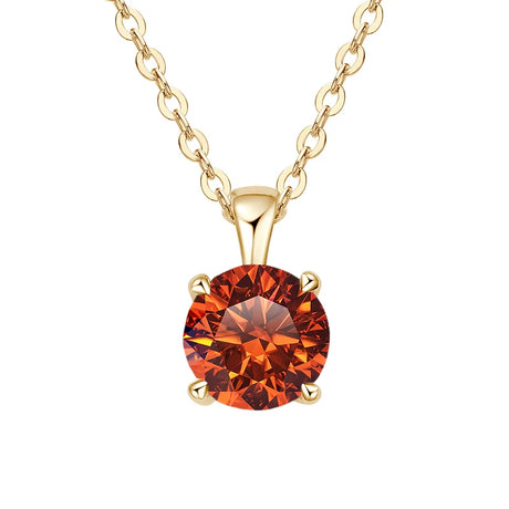 Gold necklace with a red gemstone pendant on a white background