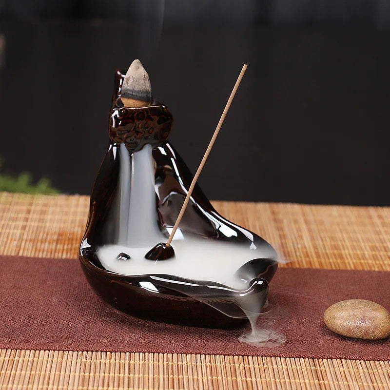 Incense burner with incense sticks on a woven mat