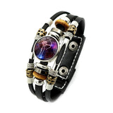 Multistrand bracelet with beads and a central circular design on a white background