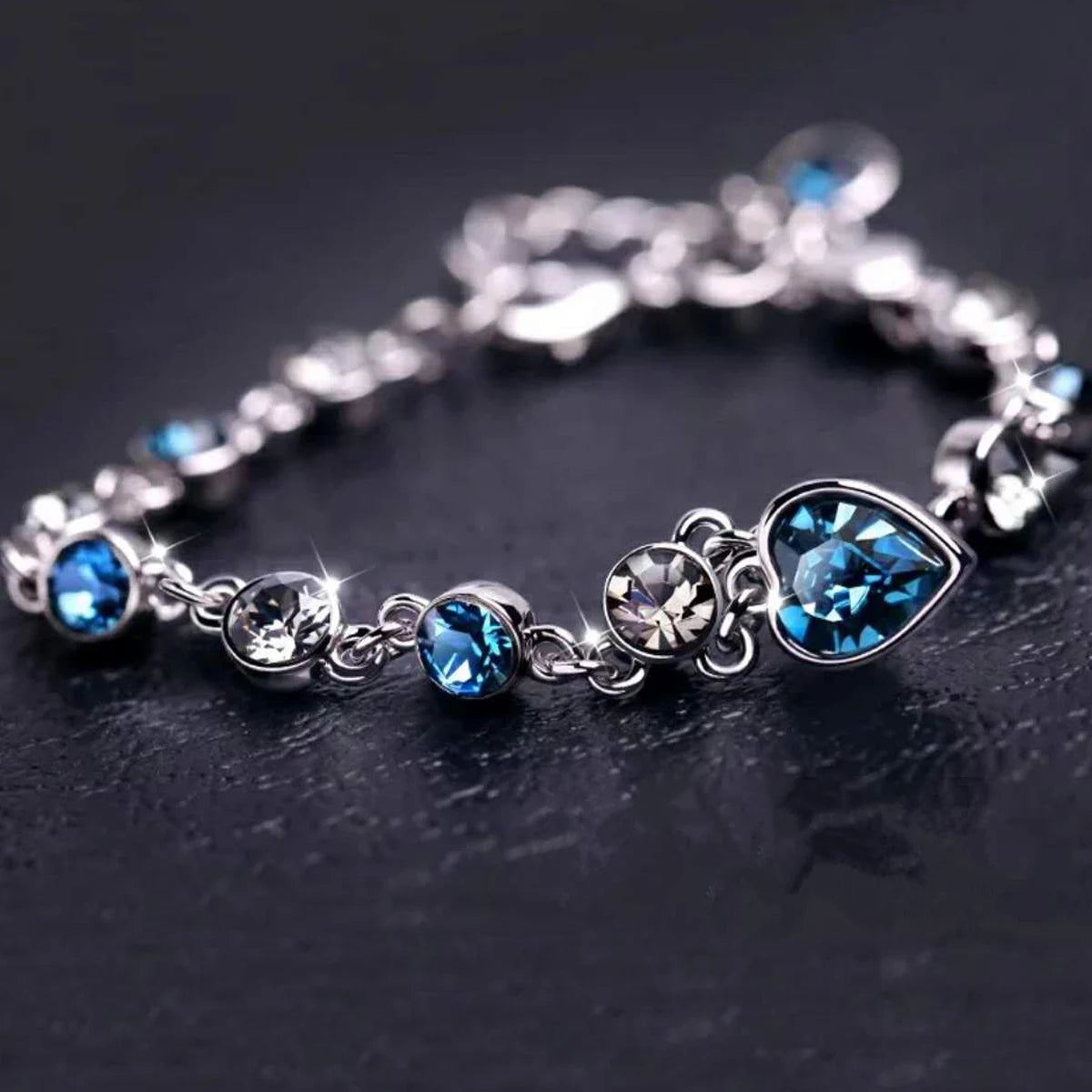 Silver bracelet with blue gemstones on a dark background