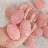 Pink stones on a hand with a neutral background