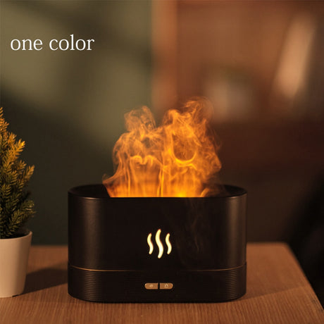Black fire pit with flames on a wooden surface, blurred background