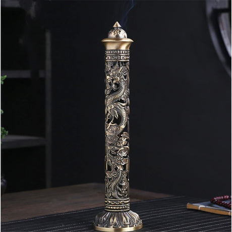 Decorative incense holder with intricate designs on a dark background