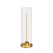 Cylindrical lamp with a gold base on a white background