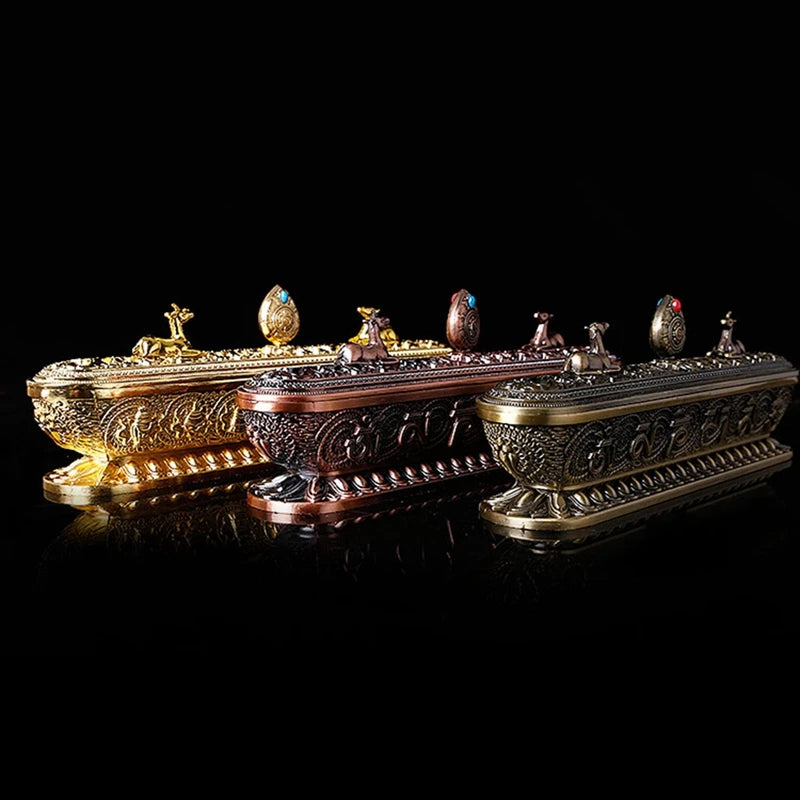 Decorative set of ornate boxes with intricate designs on a black background