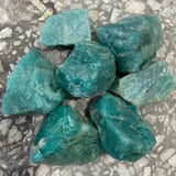 Raw turquoise stones on a textured surface