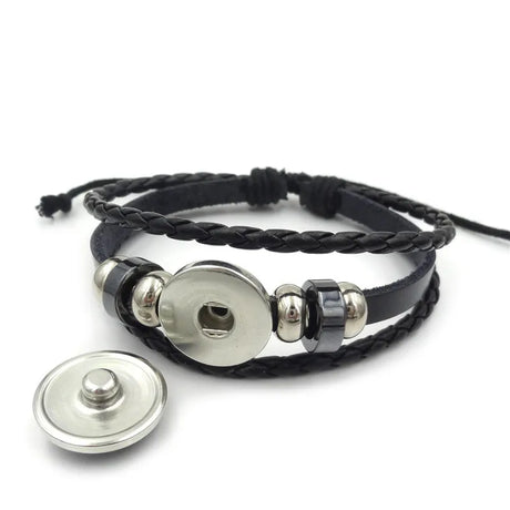 Black braided bracelet with silver button closures on a white background