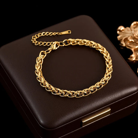 Gold chain bracelet on a black jewelry box