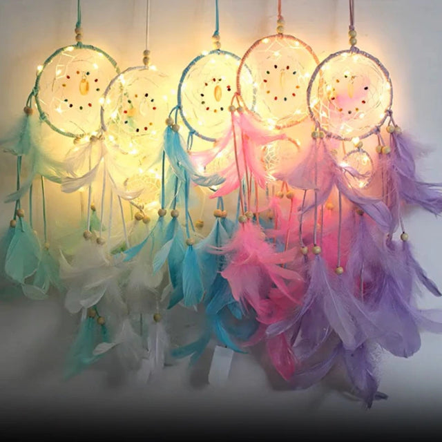 Colorful dreamcatchers with feathers and lights on a white background