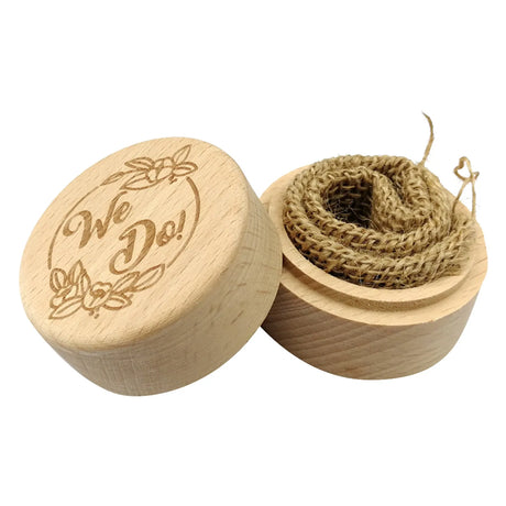 Wooden box with 'We Do!' engraving and burlap inside on a white background