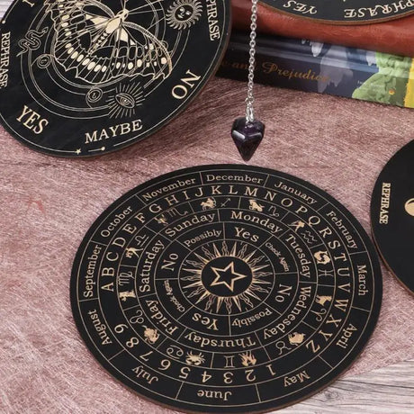 Black circular feng shui wheel with astrological symbols on a wooden surface