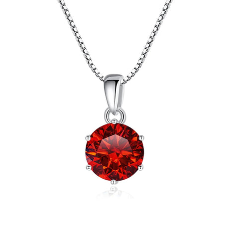 Red gemstone pendant on a silver chain against a white background
