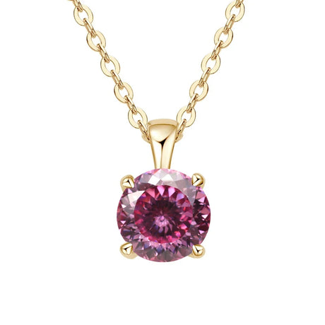 Gold necklace with a pink gemstone pendant on a white background