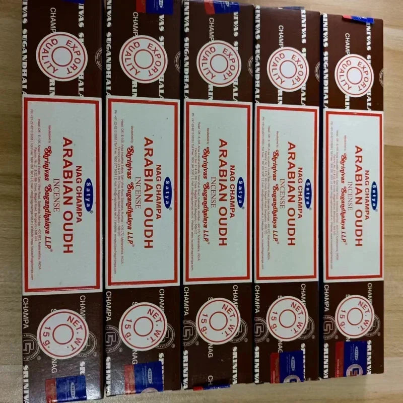 Multiple boxes of Arabian Oudh incense sticks on a wooden surface