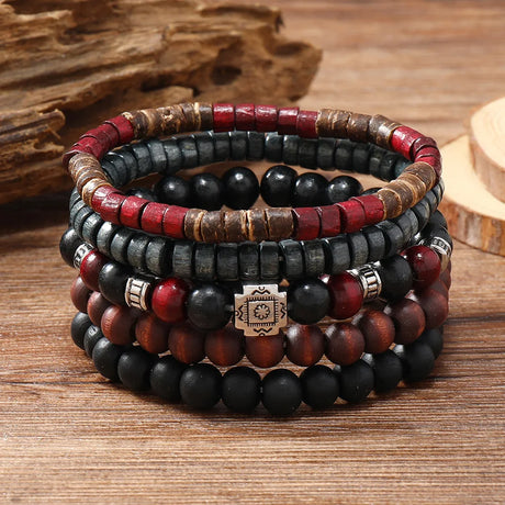 Stack of beaded bracelets with red, black, and brown colors on a wooden surface.