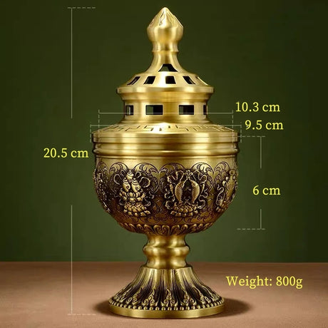 Decorative brass incense burner with measurements and weight on a green background