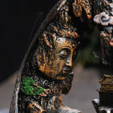 Close-up of a detailed bronze statue with a blurred background