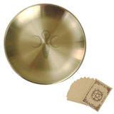 Gold dish with a symbol and a set of cards featuring the same symbol on a white background
