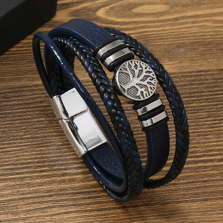 Blue braided leather bracelet with silver metal elements on a wooden surface