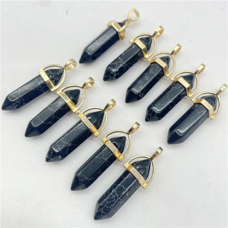 Set of dark blue crystal pendants with gold accents on a light gray background