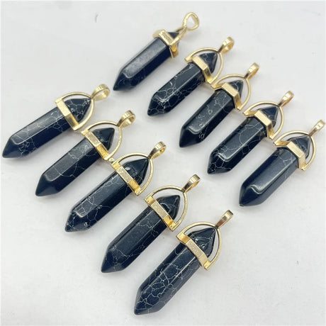Set of dark blue crystal pendants with gold accents on a light gray background