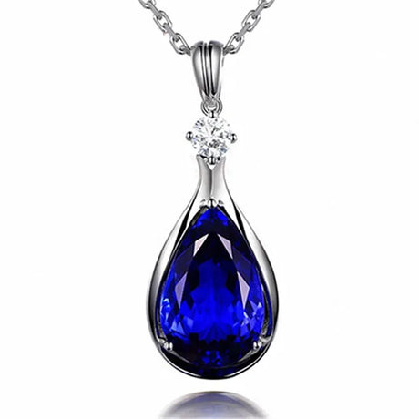 Blue teardrop pendant necklace with a silver chain on a white background