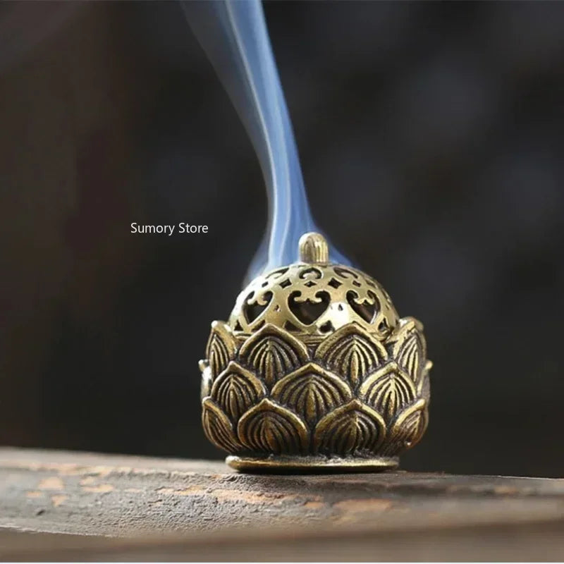 Bronze incense burner with smoke against a dark background