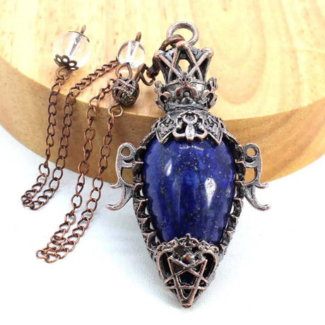 Necklace with a blue stone pendant on a wooden surface