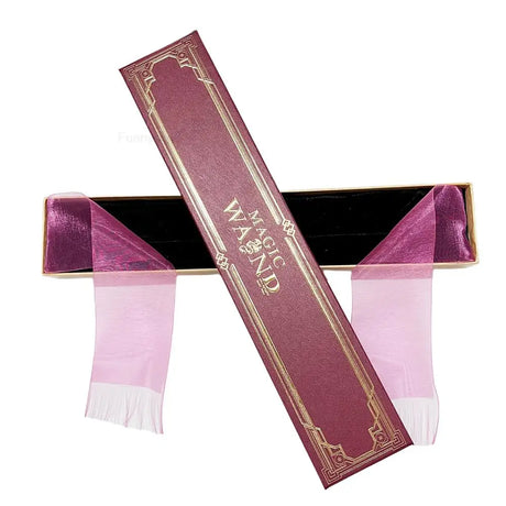 Pink and purple magic wand with decorative packaging on a white background