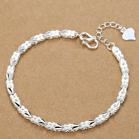 Silver bracelet on a brown background
