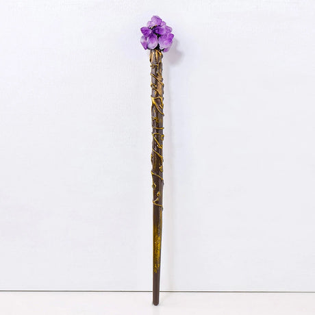 Decorative wand with a purple flower top on a white background