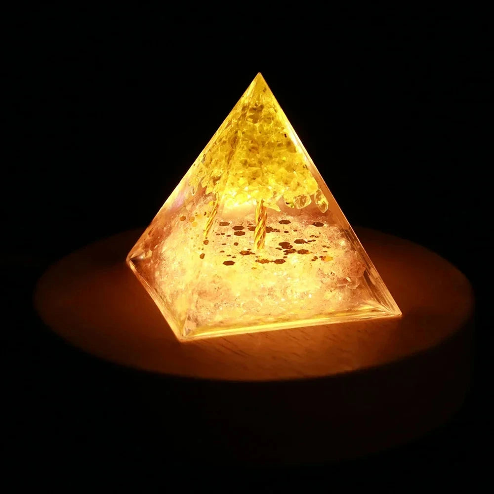 Pyramid-shaped light emitting a warm glow on a dark background